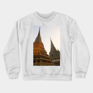 Third view of two stupa against sky at Wat Pho Crewneck Sweatshirt